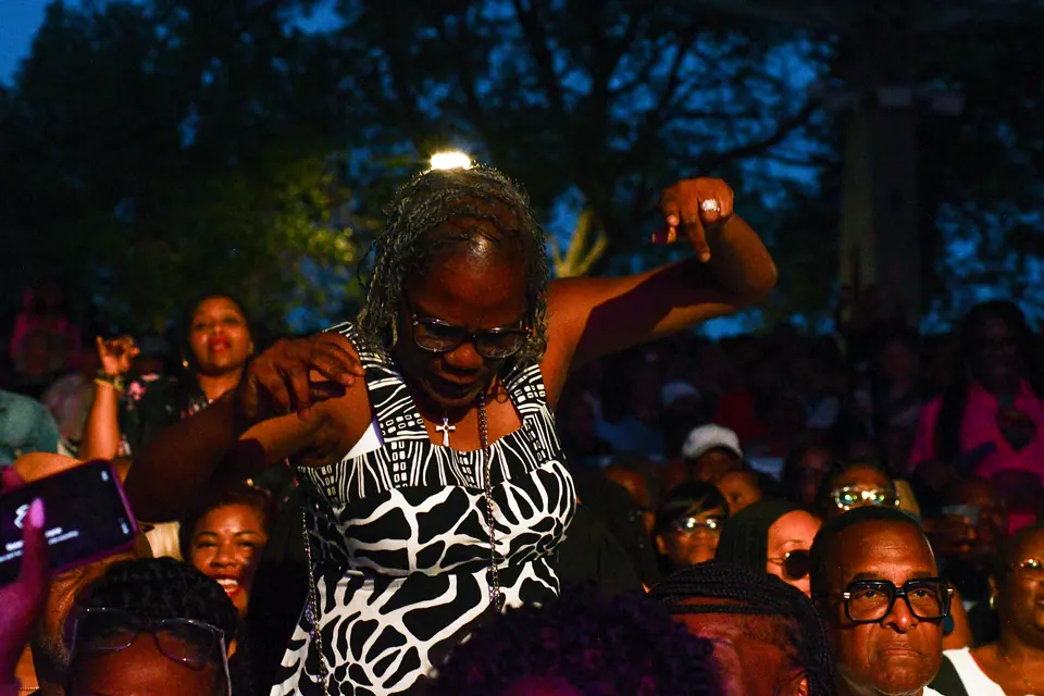 A guest dances in the aisle at dusk
