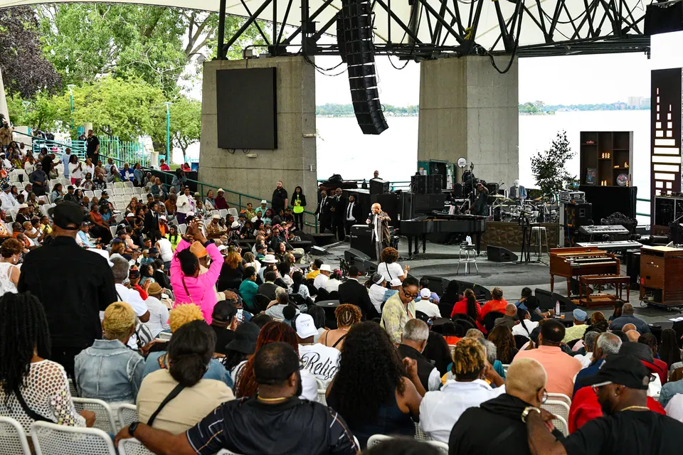 Guests fill the amphitheatre seating with the Detroit River behind the stage